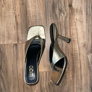 Gold heeled mules.